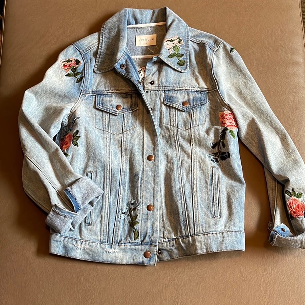 Light wash jean jacket with embroidered flowers
